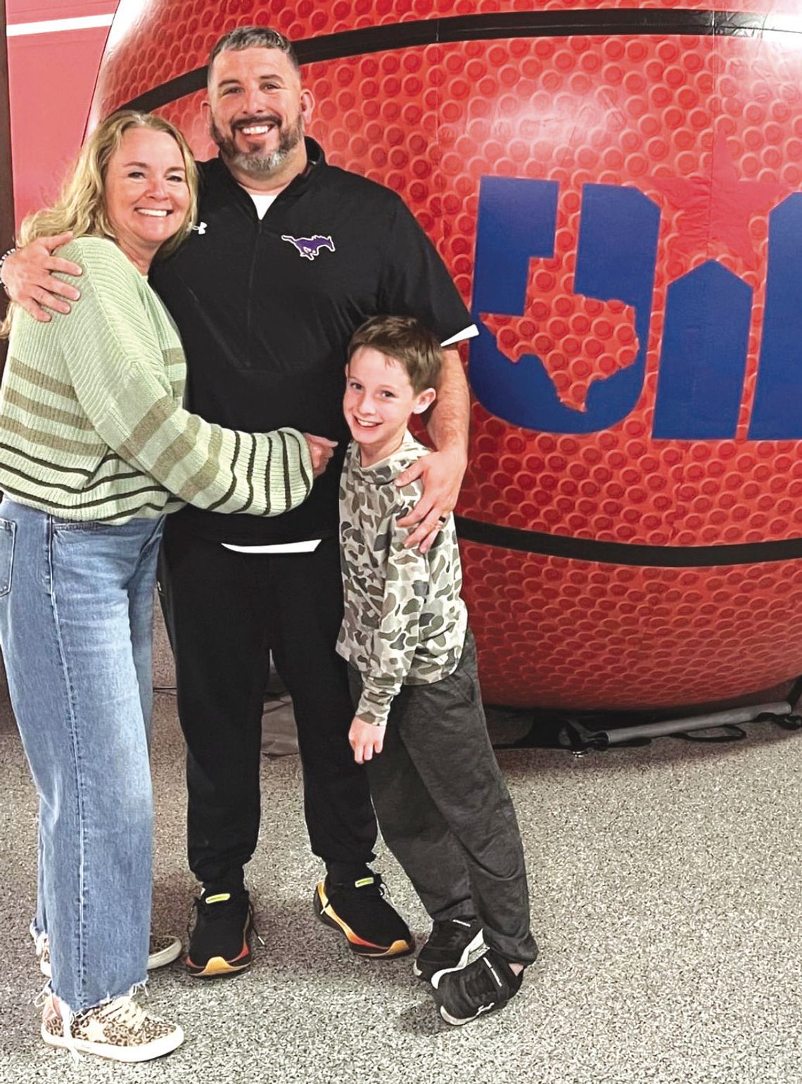 Sonny Wilson (center) is joining the Georgetown High School staff with the full support of wife Carrie and son Ryder. Contributed photo