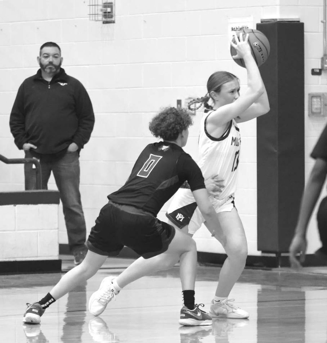 Marble Falls senior guard Kenadie Cotton is bumped as she prepares to pass the ball against Taylor.