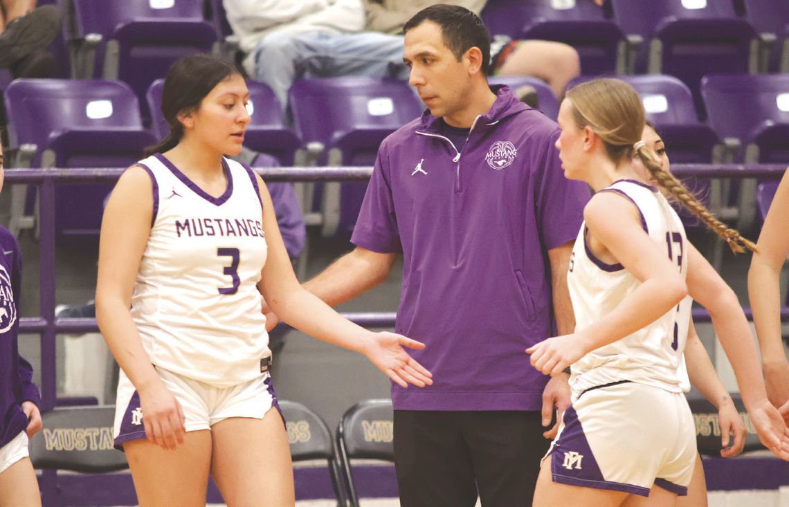 Marble Falls head coach Adley Canales (center) and the Lady Mustangs finish the first round of District 24-4A play.