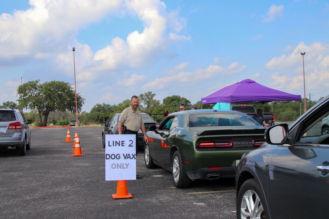 Volunteer Jason Jewett helped guide a recent drive-through pet vaccination clinic at Marble Falls High Schools. Additional free clinics are scheduled for July 13 and 17 in Bertram and Llano. Martelle Luedecke/Luedecke Photography