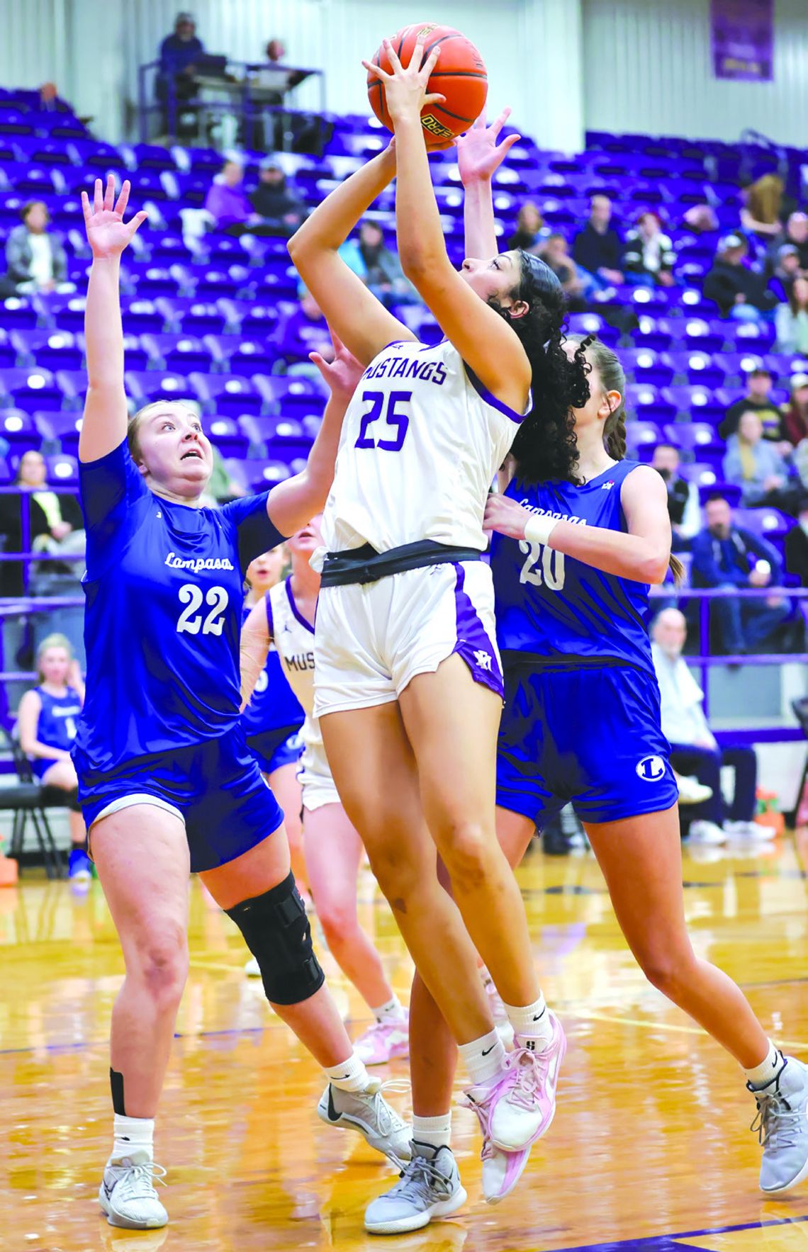Marble Falls senior guard Kenadie Cotton draws contact as she attempts a short jumper against Lampasas.