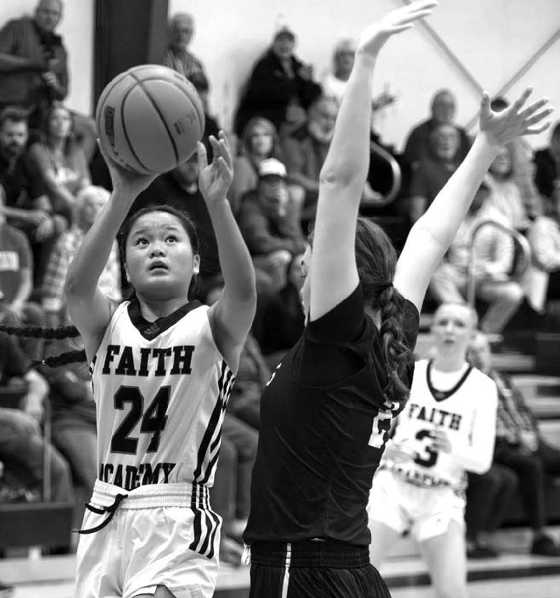Faith Academy of Marble Falls fresh- man Jasmine Young doesn't allow a defender to sway her from shooting. Contributed photos/Stennis Shotts