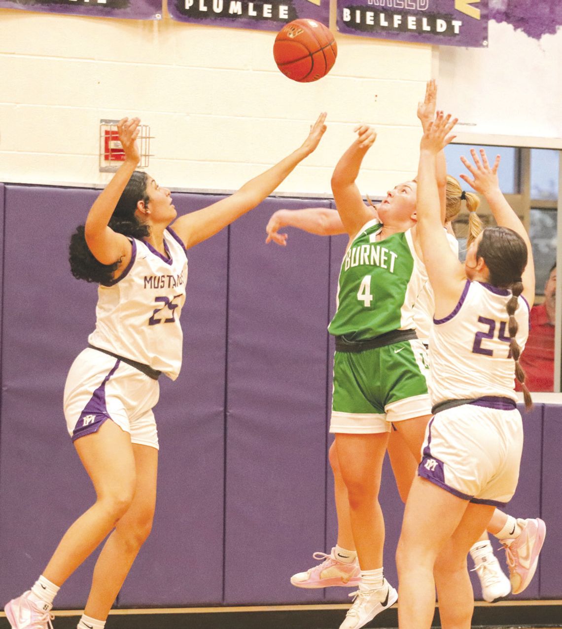 Getting high-percentage baskets required players to be un- afraid to take the pounding that comes with that territory of the court as illustrated by Marble Falls junior forward Leslie Reynoso (24) and sophomore Kinley Virdell (24) and Burnet junior guard Peyton Allen (4). Photos by Martell...