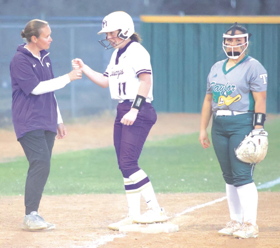 Assistant coach Hailey Wooten congratulates senior Sophia Biagini for a big hit that brought runners home against Taylor. Photos by Jennifer Fierro/TexasChalkTalk.com