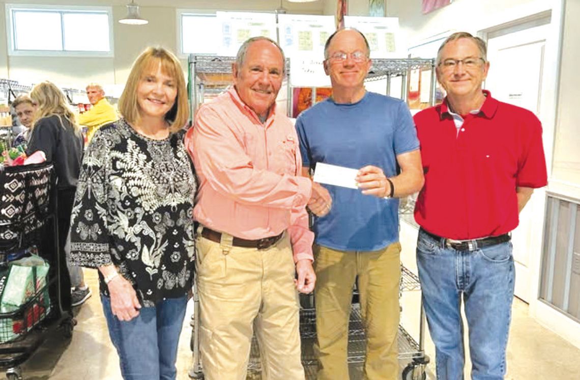From left, The Helping Center administrative assistant Carol Hall, Rotarian Gil Jones, The Helping Center board president Paul King and Executive Director Sam Pearce gathered for a $1,000 check pre sentation recently made possible by the Marble Falls Daybreak Rotary Club. Contributed photo