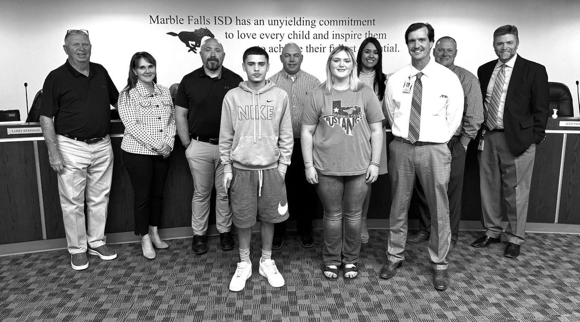Pictured, from left, are Falls Career High School students Isaiah Bedell and Breeanna Paulk (front, center) with Falls Career High Principal Clark Fields. The Marble Falls ISD Board of Trustees is pictured in the background. Contributed/MFISD