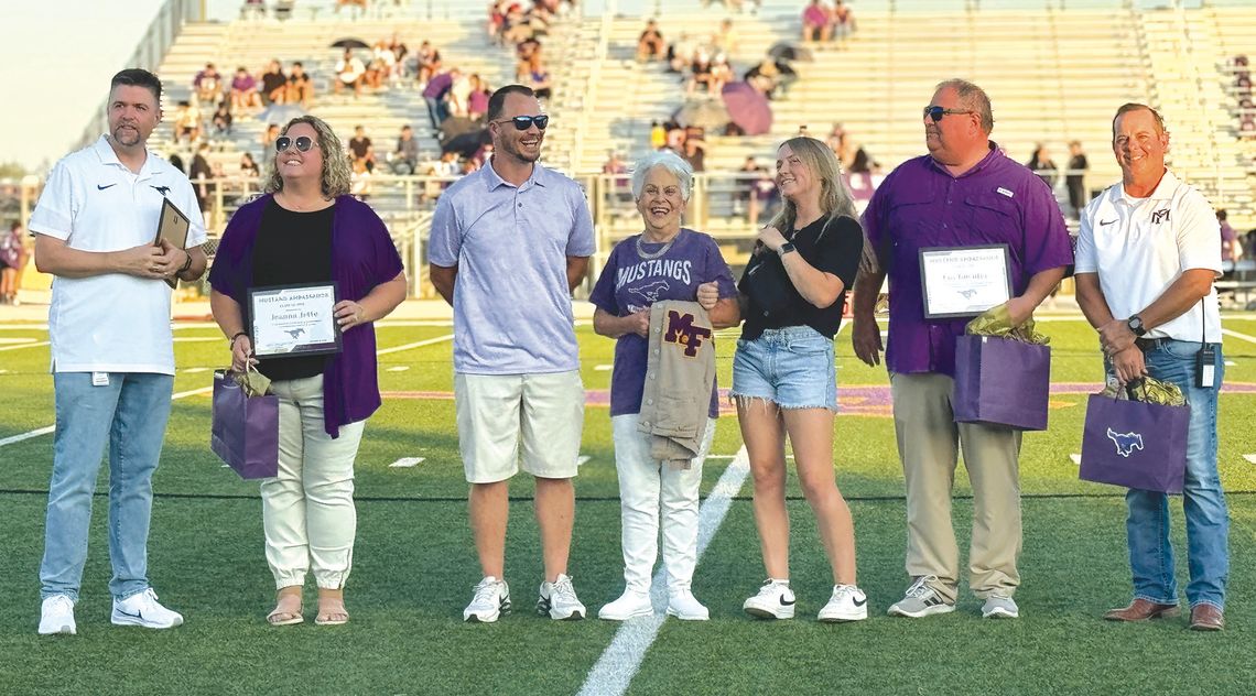 Contributed/ MFISD MFISD Superintendent Jeff Gasaway, at left, and Stan Whittle, at right, posed with Mustang ambassadors Jeanna Jette, Mary Ulbricht (with her grandchildren Charlie Ulbricht and Rylie Ulbricht) and Coy Guenter at the Homecoming game Sept. 20.