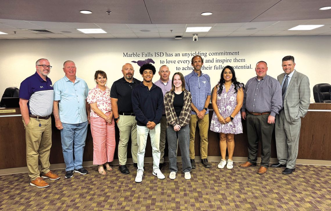 Two Superintendent's Awardees, student council president Isaiah Lazos and 2025 valedictorian Emma Cayce, accepted congratulations from school leaders behind them, from left, Principal Patrick Hinson, school board members Larry Berkman, Mandy McCary, Gary Boshears, Kevin Virdell, Alex Payso...