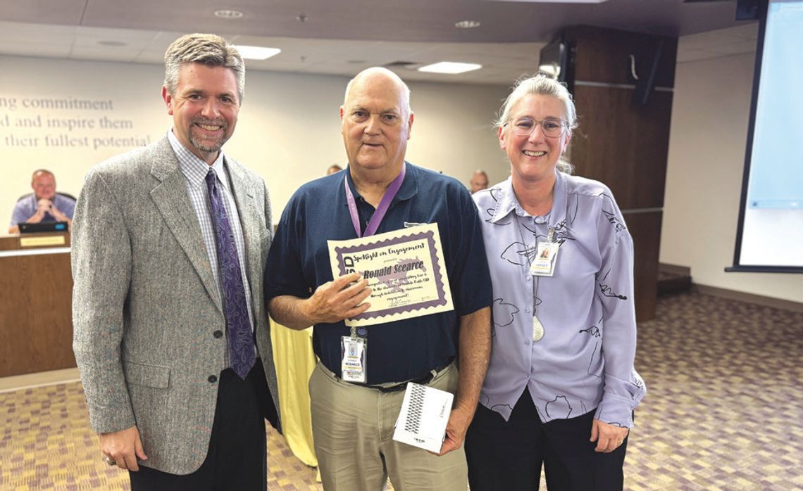 Coach Ronnie Scearce, with Superintendent Jeff Gasaway at his right and Assistant Superintendent of Curriculum and Instruction Yarda Leflet at his left, was presented with the Spotlight on Engagement Award for his decades of service and commitment to students.