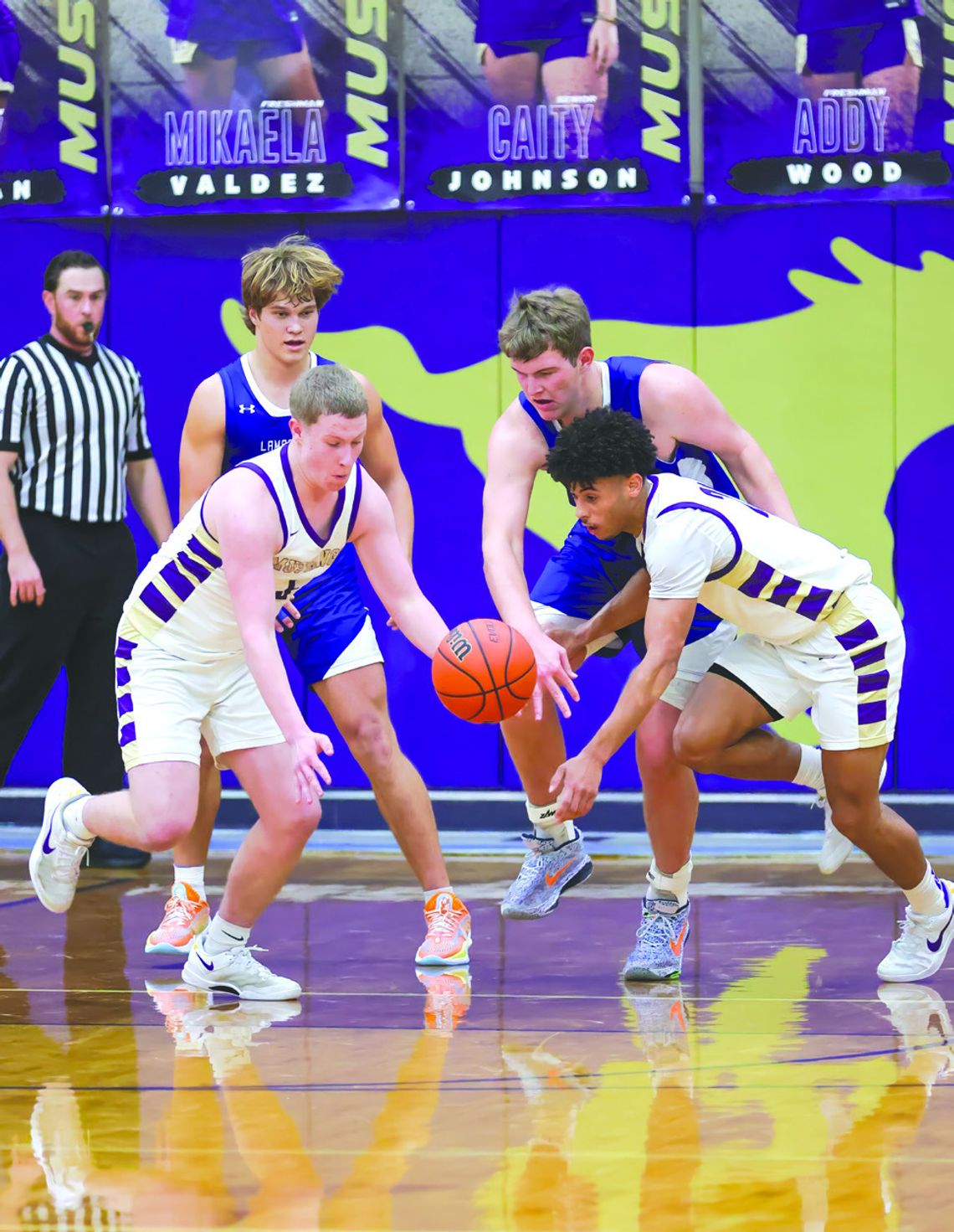 Contributed photos by Christopher A. Miles/ Christopher A. Miles Photography Marble Falls seniors Noah Wylie (left) and Tidus Willie go after the loose ball to get another crucial possession against the Lampasas Badgers.