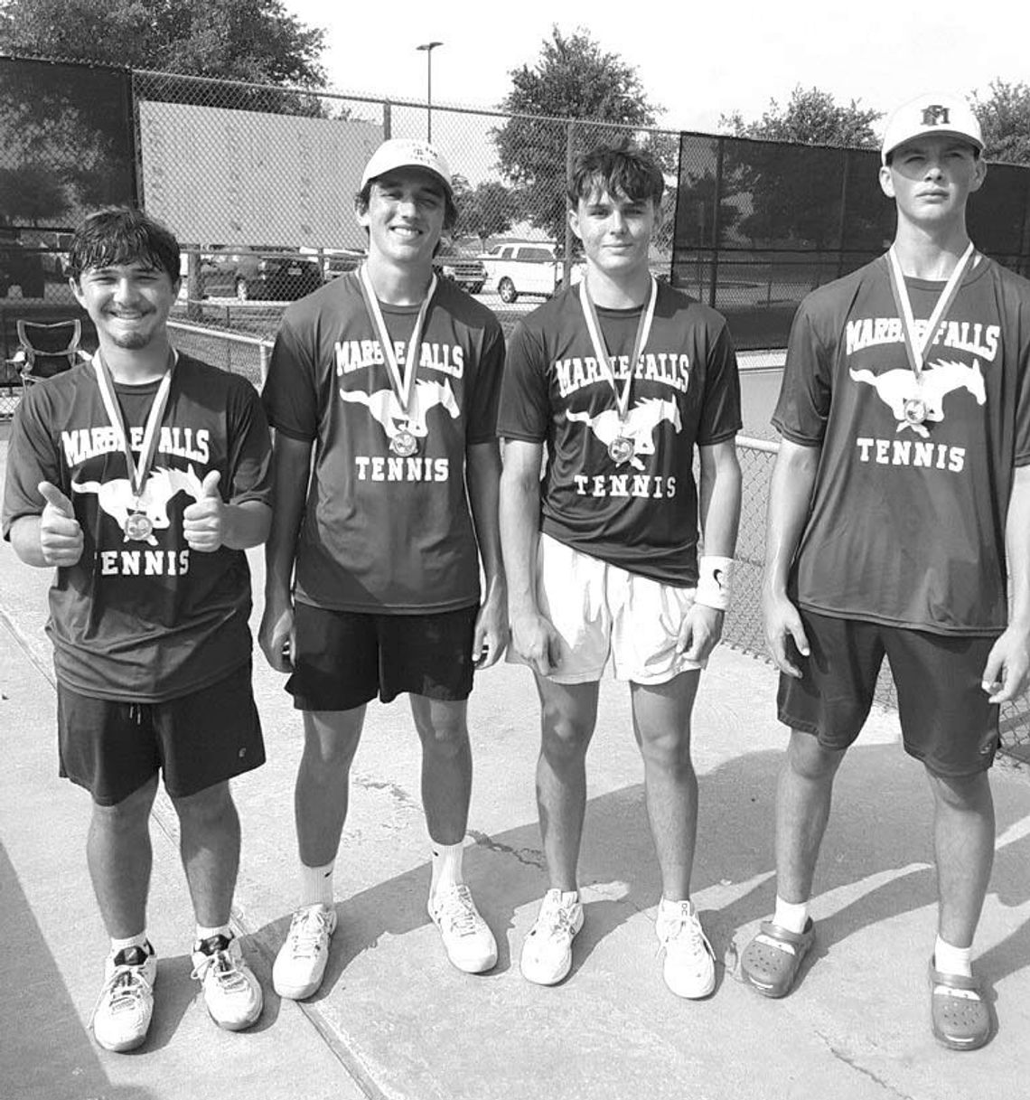 and Cooper Kelley wear their gold medals and Nicolas Smith and Payton Glaser wear their silver medals signifying their finishes at the District 24-4A tournament. The boys doubles teams of Weston York (left)