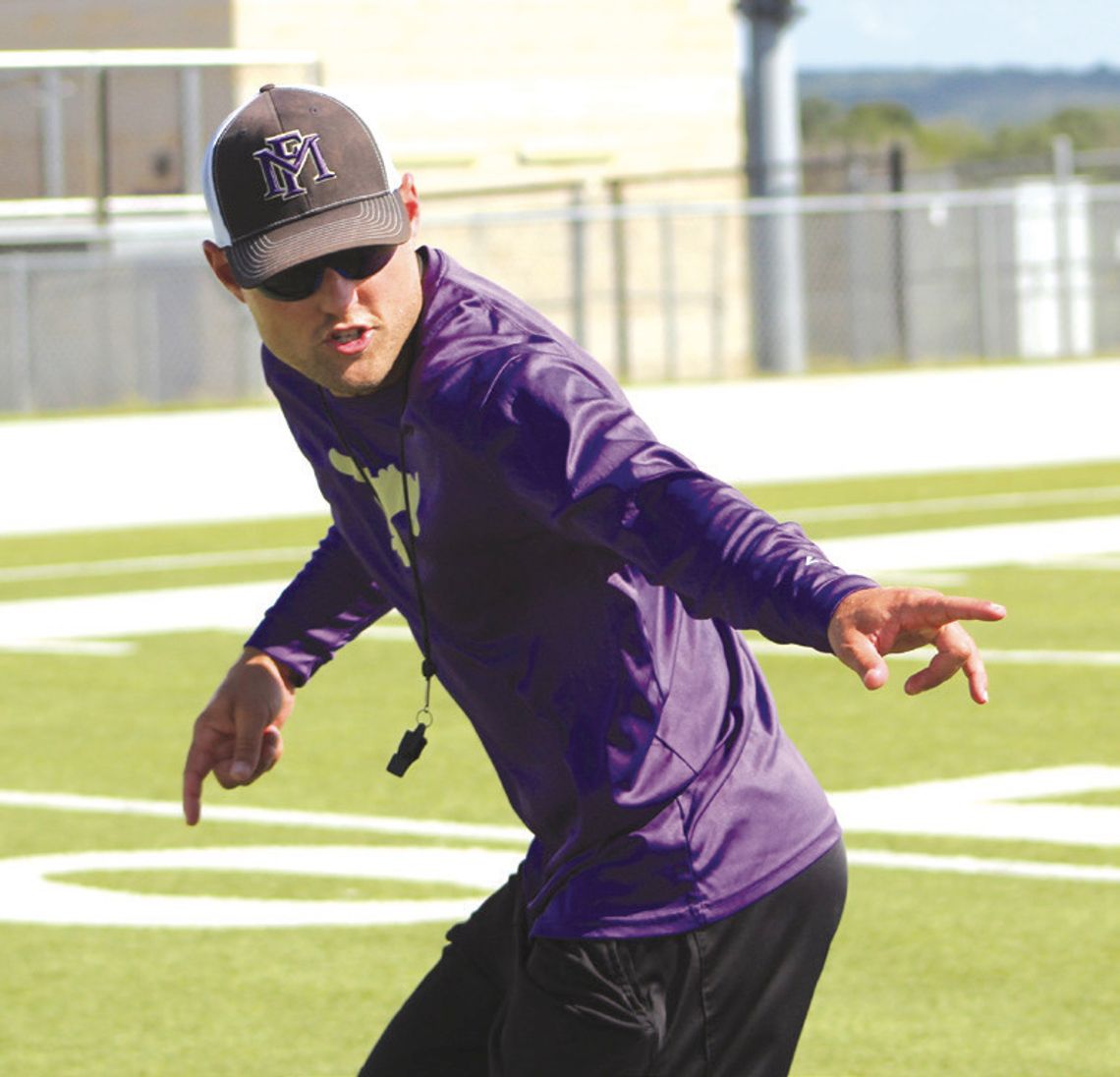 Photos by Jennifer Fierro/TexasChalkTalk.com Marble Falls defensive coordinator Ryan Craven demonstrates how he wants the defensive backs to turn as they're running backward.