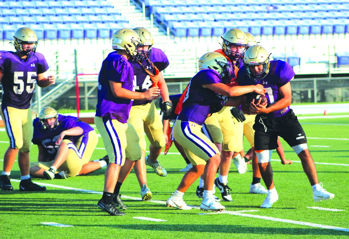 Marble Falls High School junior running back Jonathan Hernandez looks for running room and protects the ball during practice Aug. 9. Photos by Jennifer Fierro/TexasChalkTalk.com