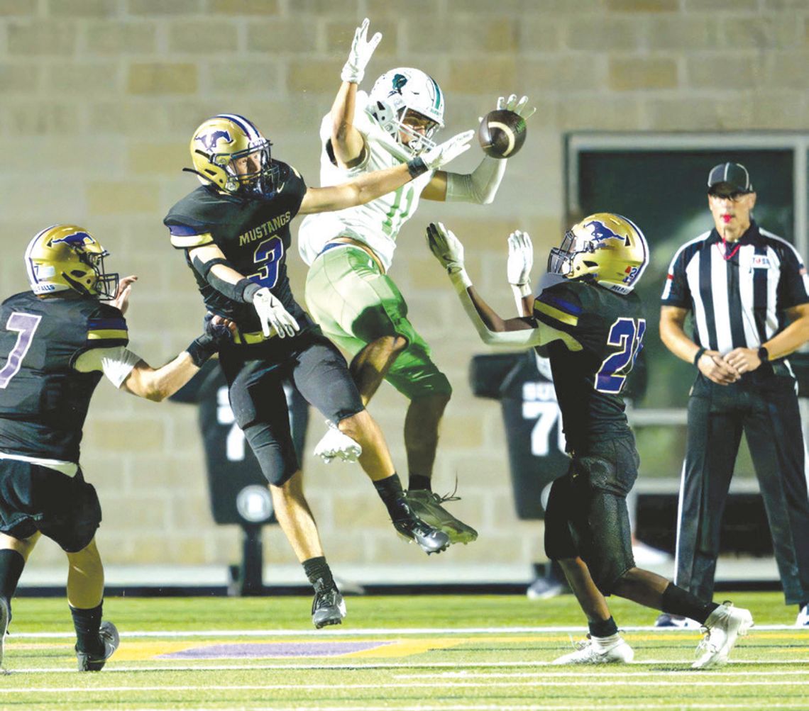 Marble Falls senior defensive back Jackson Trudeau (3) and junior defensive back Gregory Lemon (21) break up a pass intended for Burnet senior athlete Marcus Pimentel as junior linebacker Doak Timmerman (7) prepares to assist.
