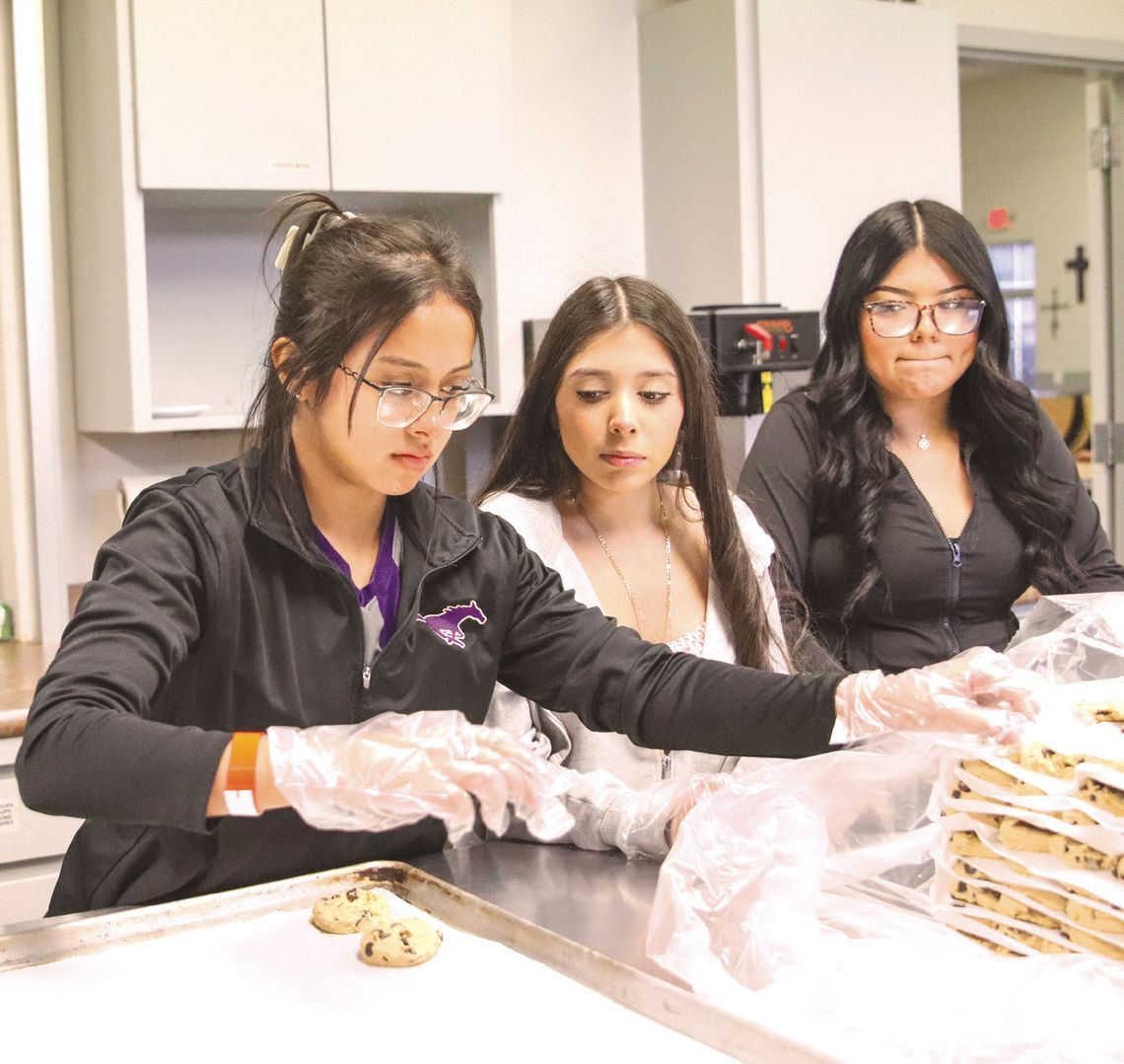 From left, Bri Avalos, Sharon Estrada and Nainna Flores baked cookies Feb. 14 at First Methodist Church in Marble Falls for Rick Edwards Day of Service. Photos by Martelle Luedecke/Luedecke Photography