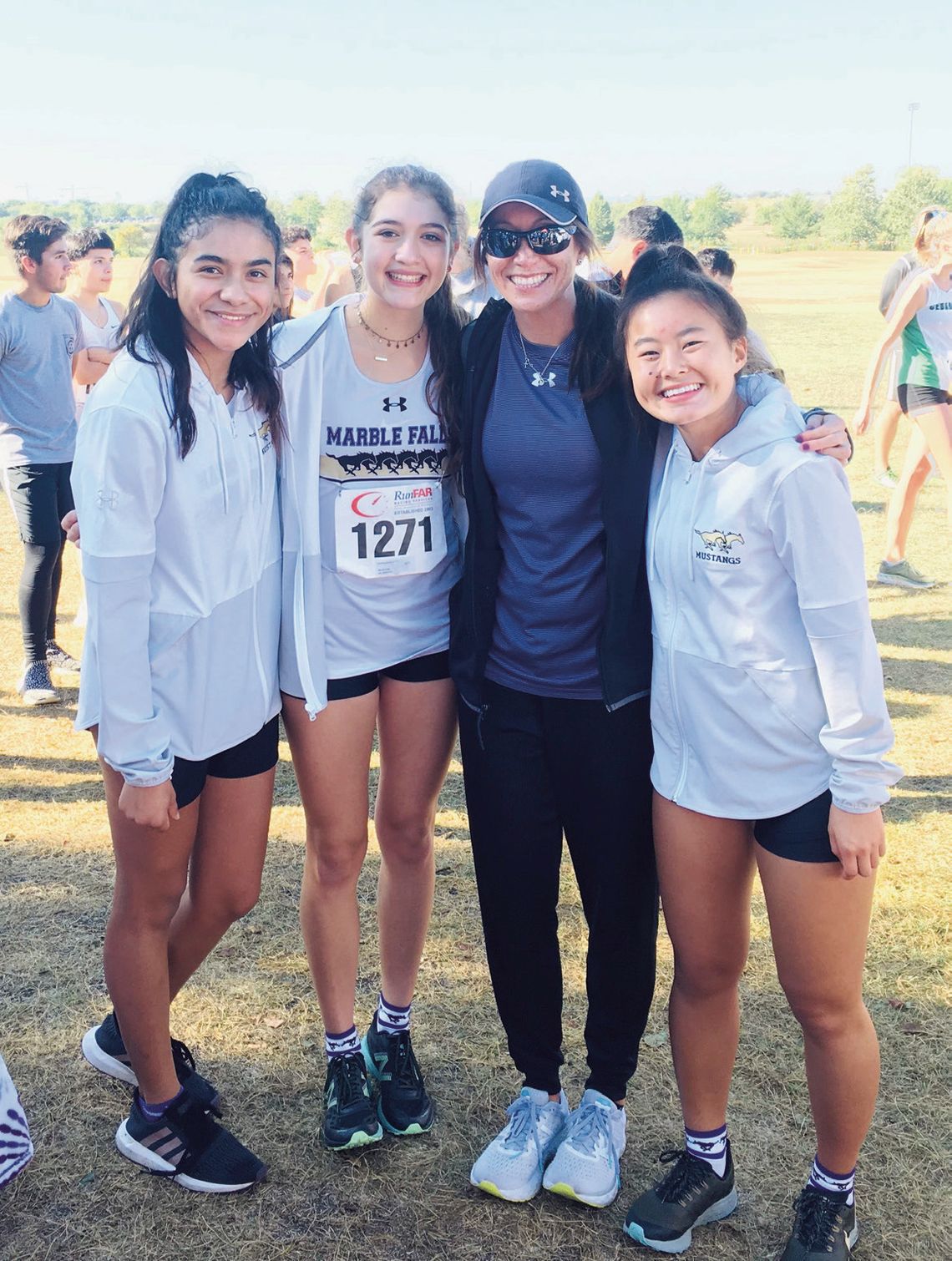 New Marble Falls cross country and girls track and field head coach Brenda Gonzalez (wearing sunglasses)may have left the school district in 2019 but never left the athletes. She is with 2020 graduates Natalie Mata (left), Ambrie Lizcano and Jaden Johnson. Contributed photo