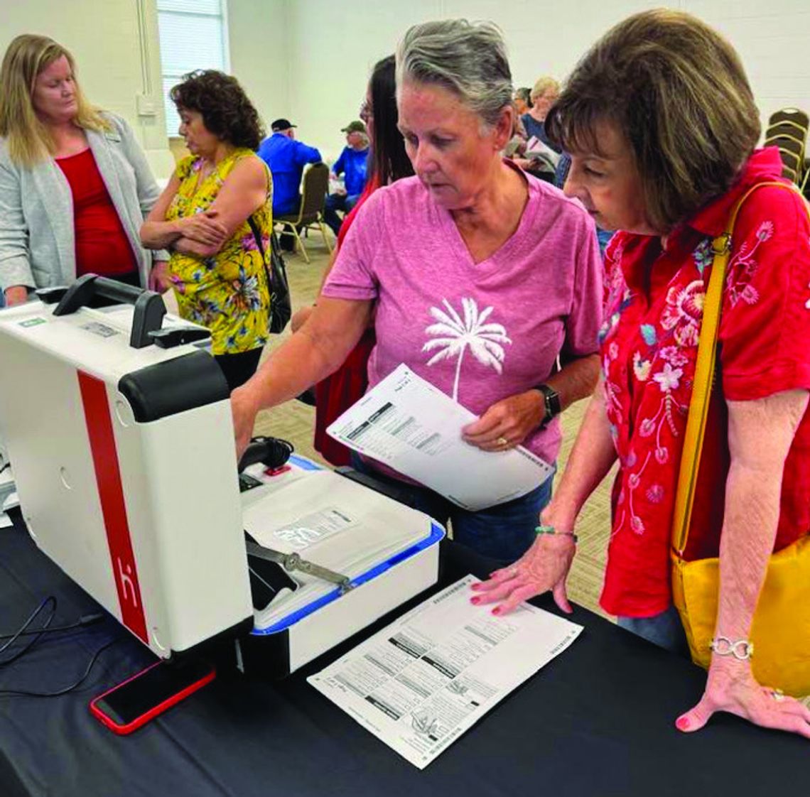 In June last year, residents Londa Chandler (left) and Darlene Hargett took a closer look at the planned new voting devices for Burnet County. The public gets an - other look on Feb. 25. File photo