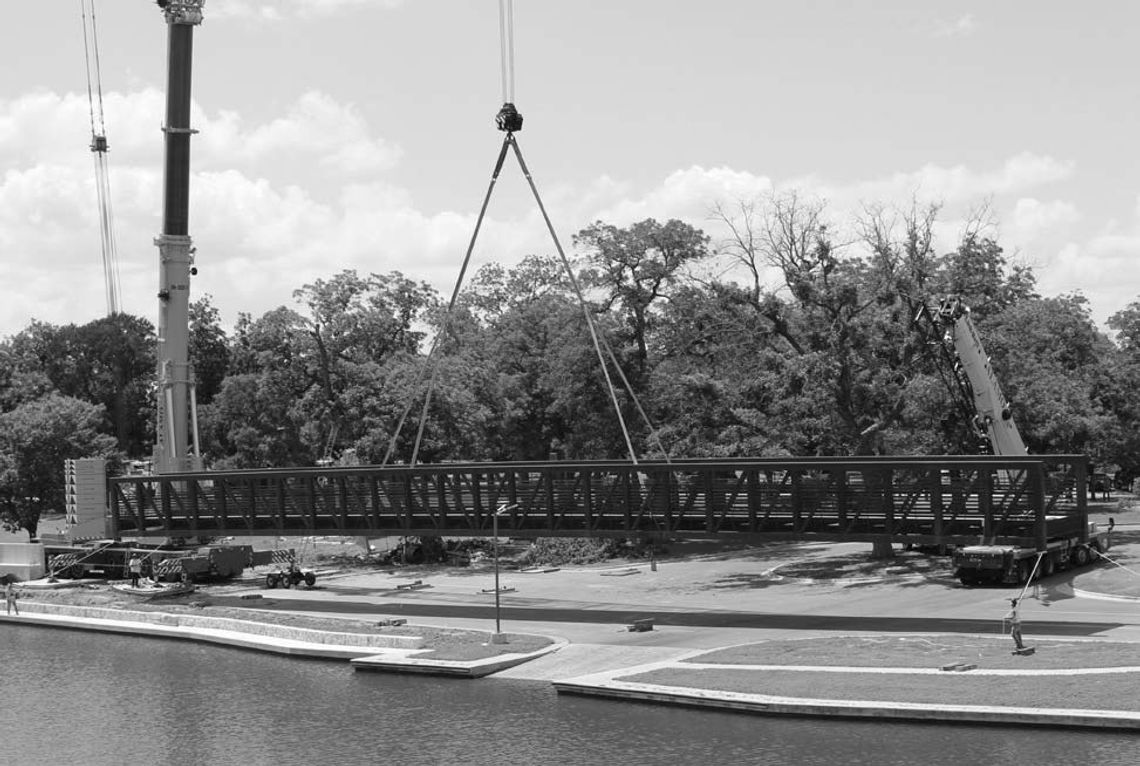 Walking bridge installation over creek underway